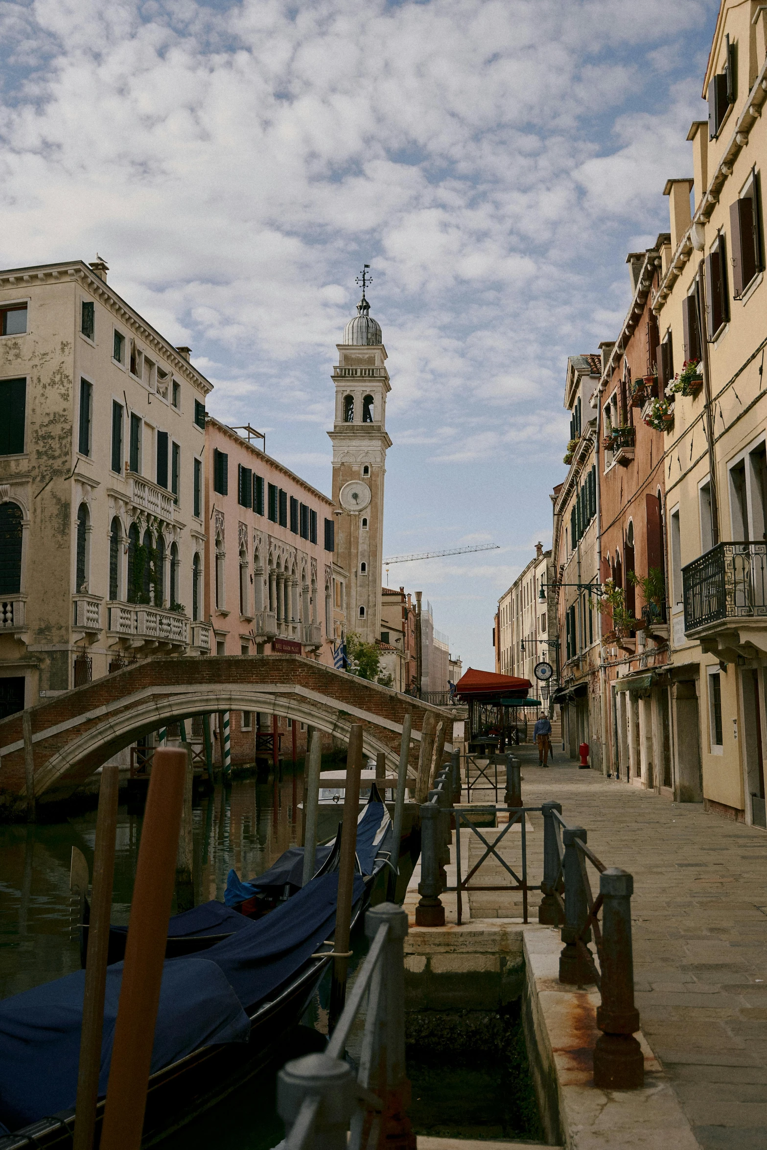 a couple of gondola sit on a bridge