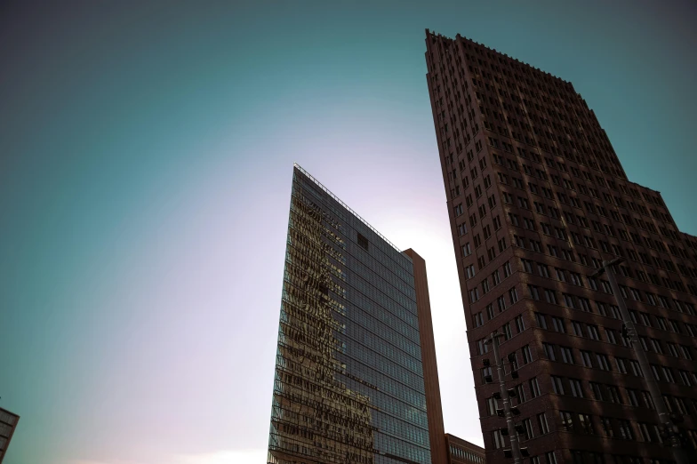 two high rise buildings against the sun set