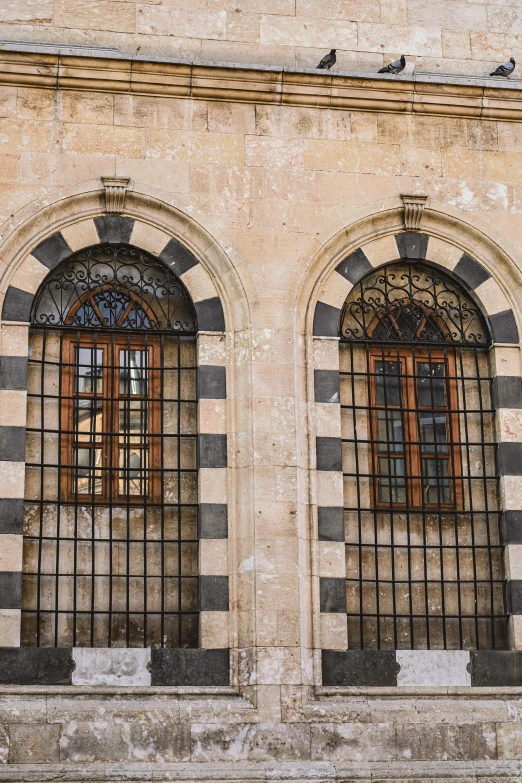 two large windows sitting next to each other on the side of a building