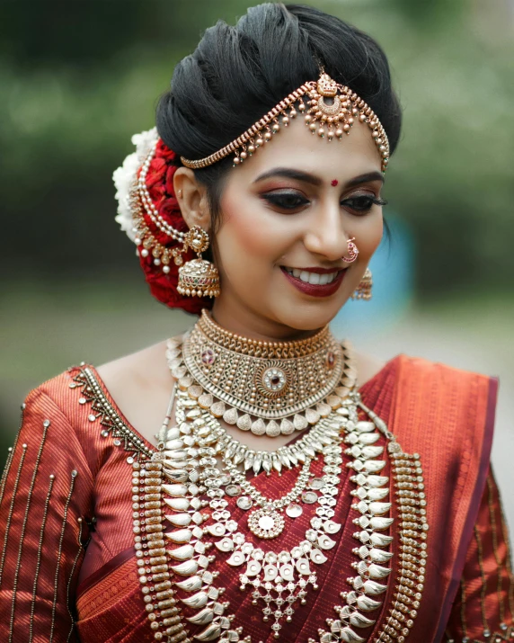 a woman wearing a traditional indian garb and jewellery