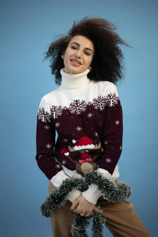 a woman sitting on top of a blue chair with christmas decorations