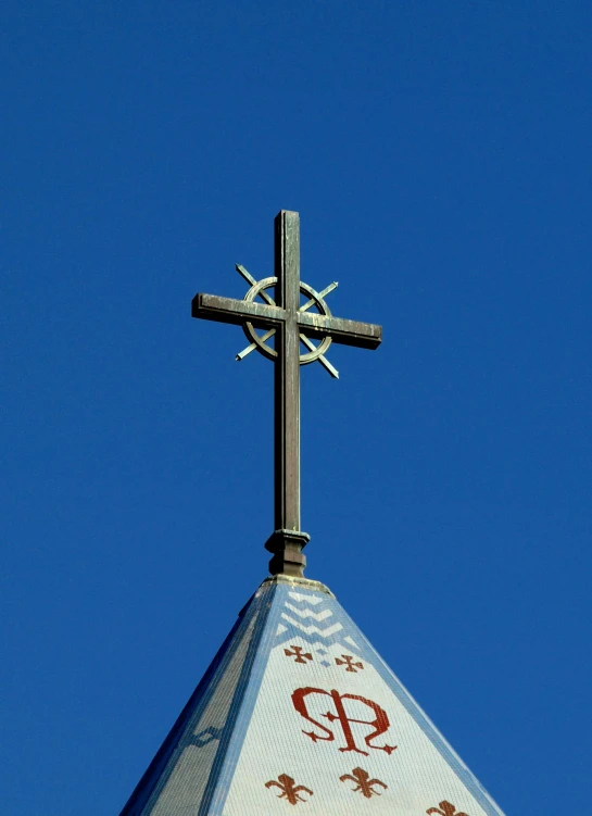 a cross atop a church steeple in red lettering