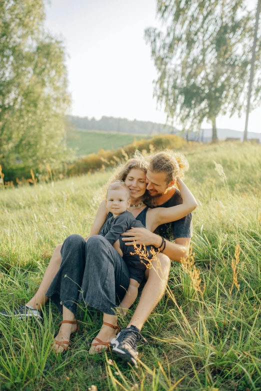 a woman and child sitting on the grass together