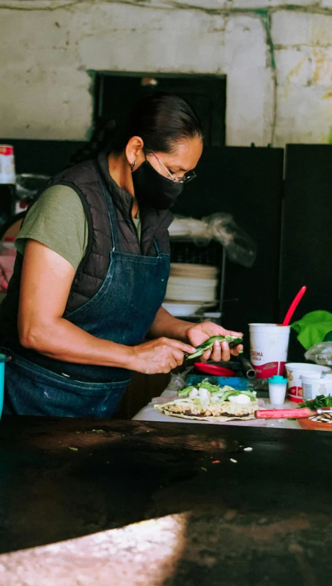 the woman is in her apron preparing food