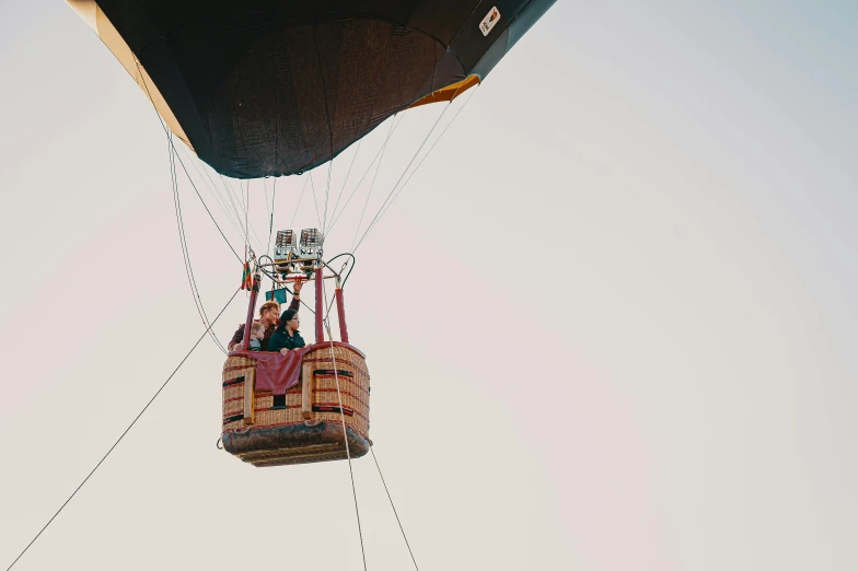 two people in a large balloon that is flying through the air