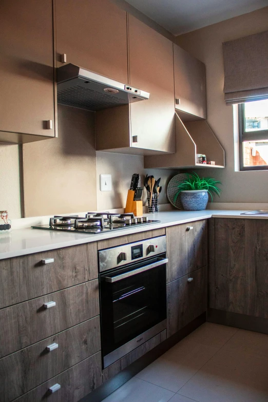 an empty kitchen with a sink, stove, and dishwasher