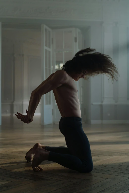a male dancer performing an intense act in the room