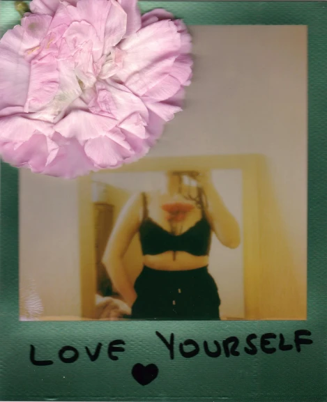 a po with a flower on top, and the words love yourself written in black on the side
