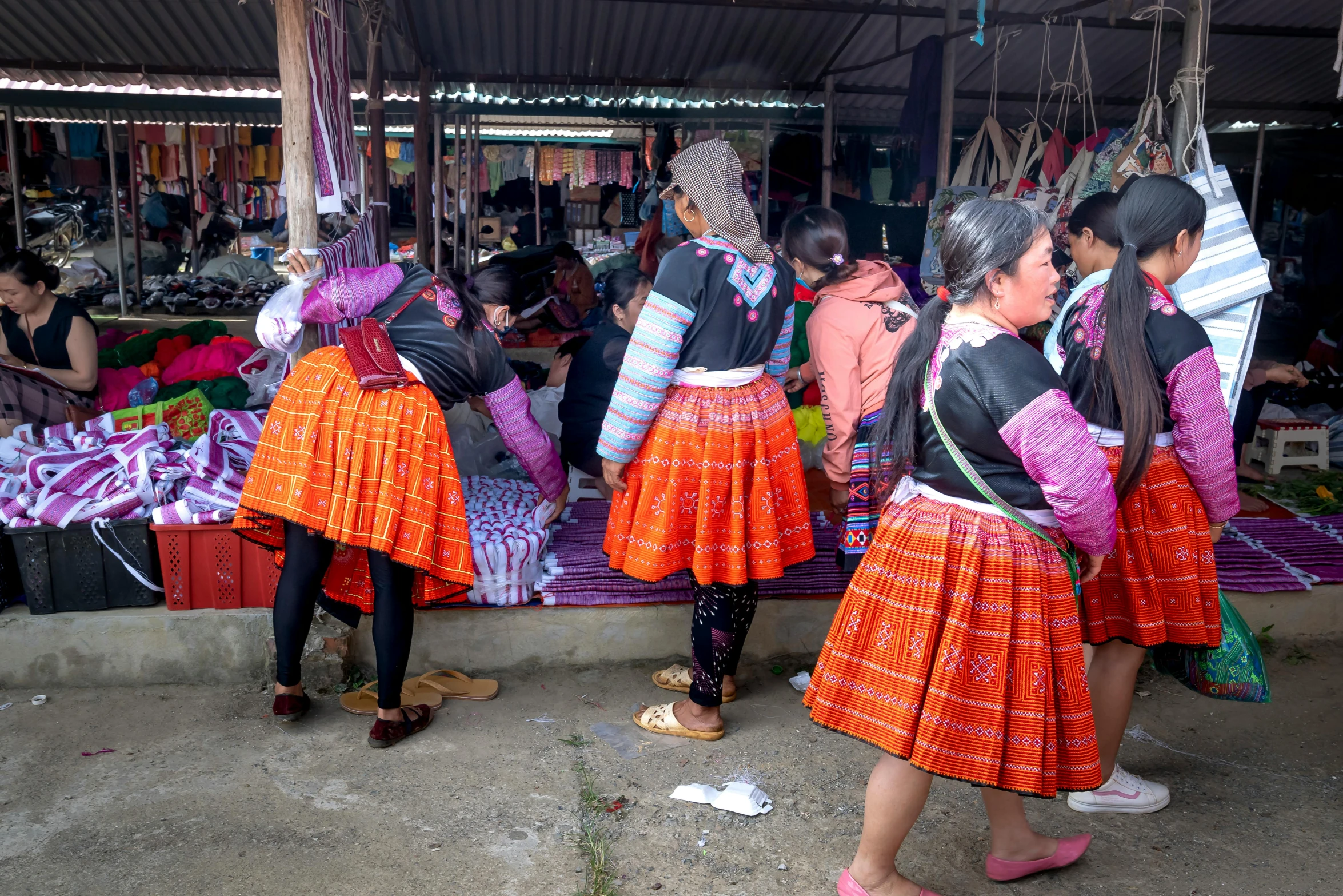 young people in colorful skirts are standing and looking at soing