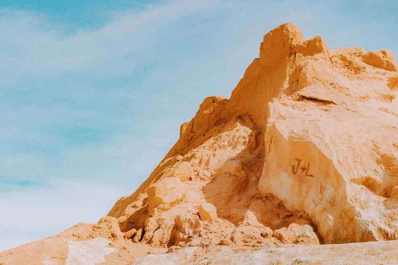 a large sand mountain with a sky background