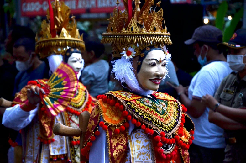 two people with masks on their face and costumed head