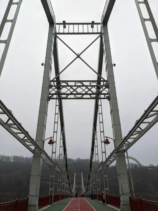 a small red path in the middle of a metal bridge