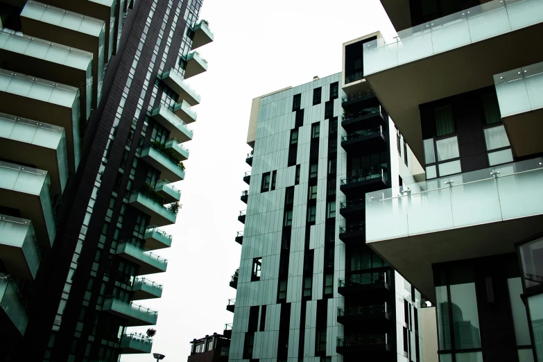 a couple of buildings are shown against a gray sky