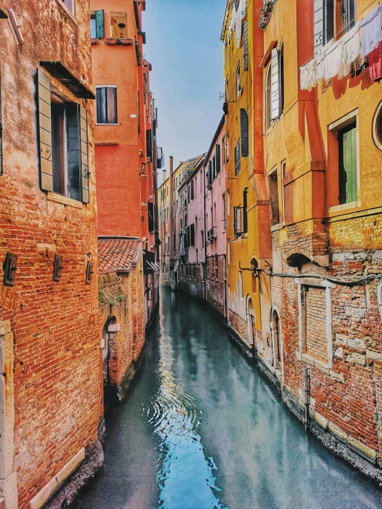 a canal with lots of water and buildings in the distance