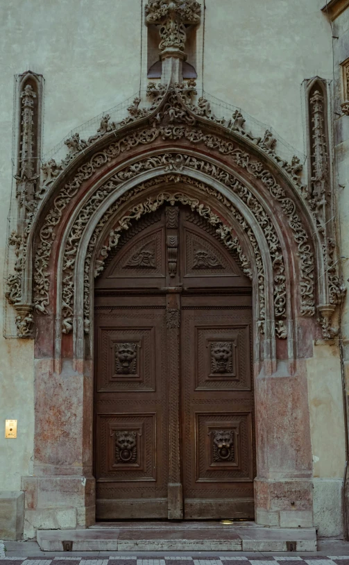 an ornate door and entrance of an old stone church