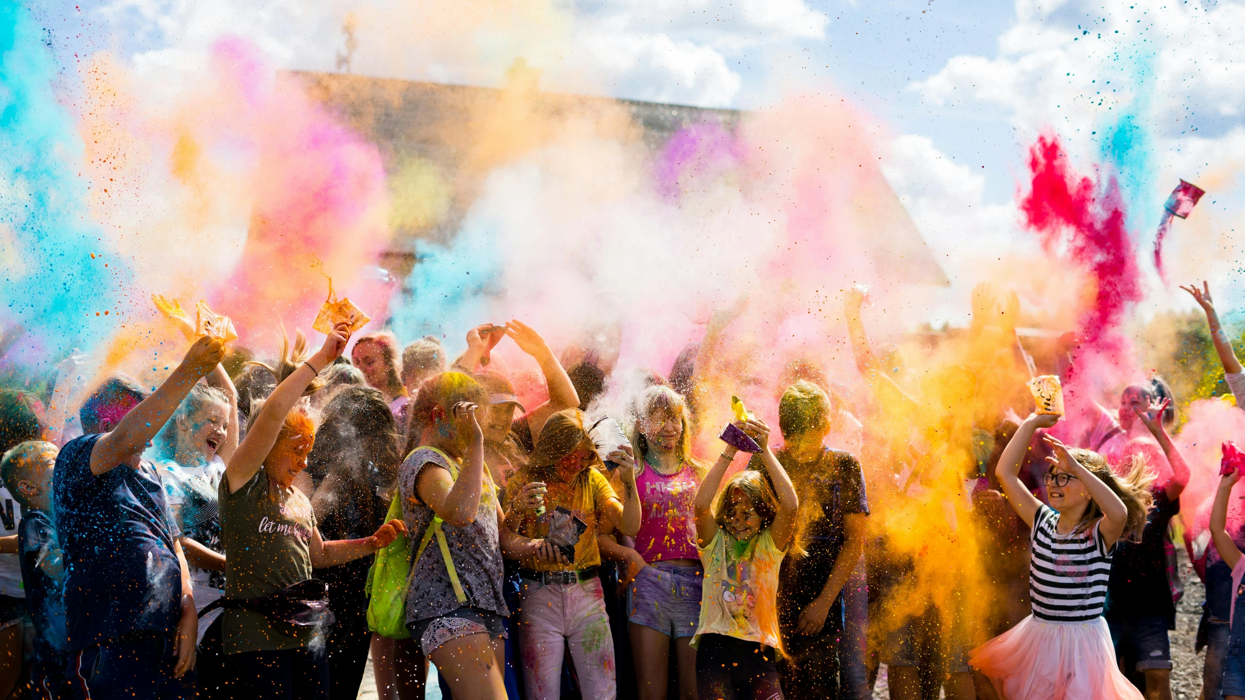 a large crowd of people celeting a festival