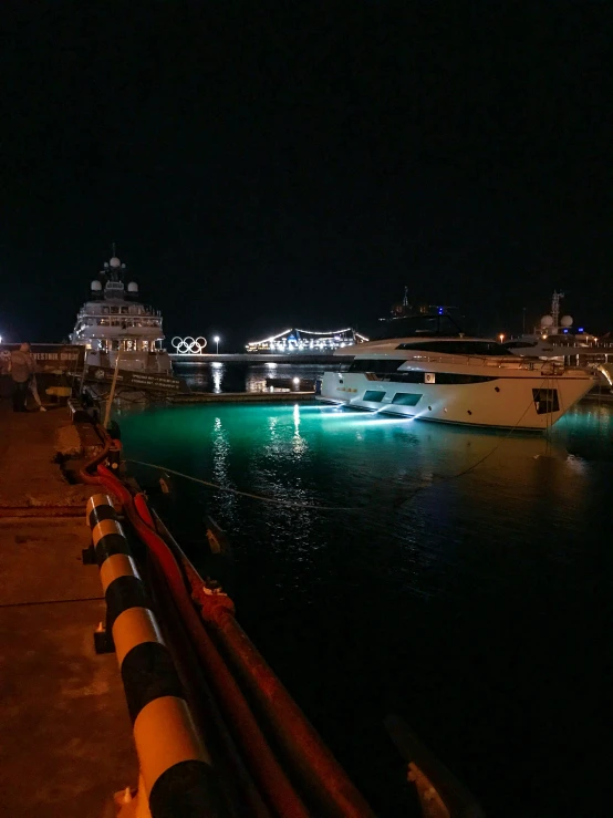 boats parked along the shore at night time