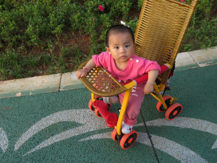 an adorable little girl is sitting in a chair