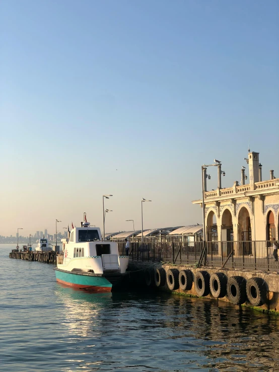 a boat sitting in front of a building on the water