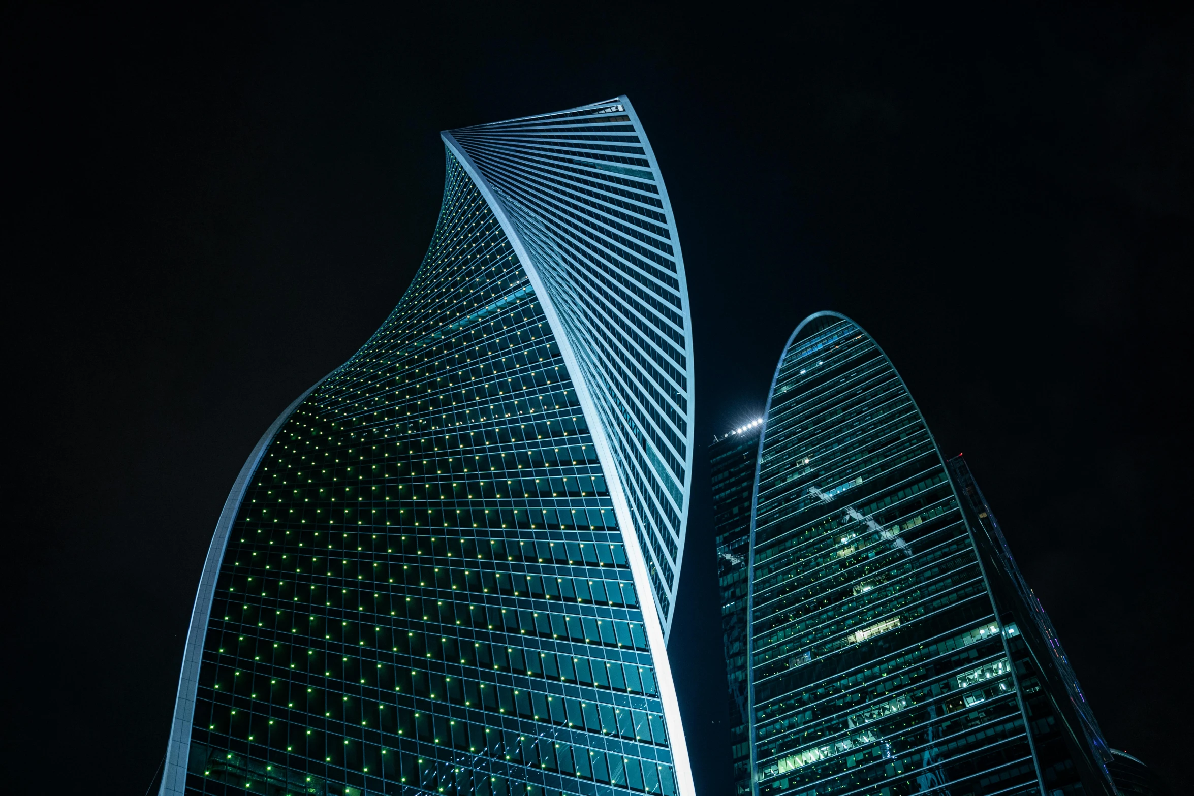 the night view of two skyscrs from below