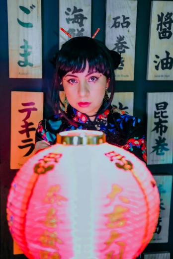 a girl is holding a lit chinese vase