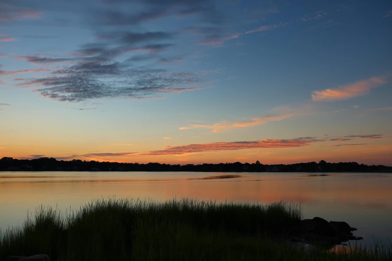 a boat out on the lake at dusk