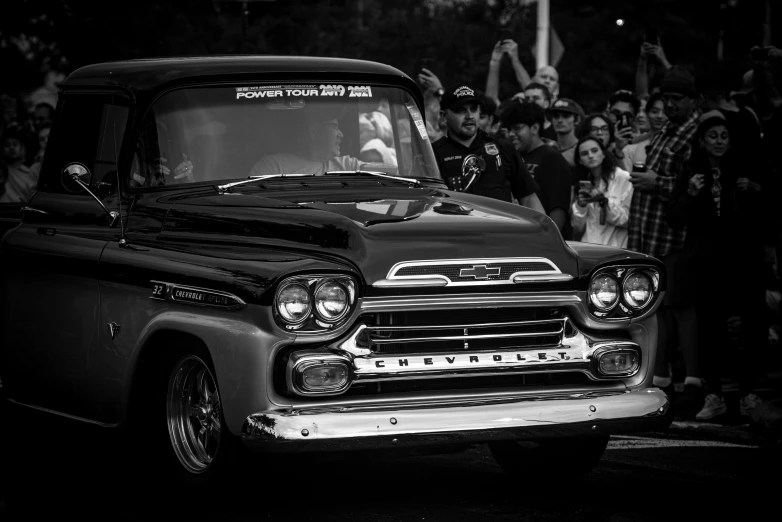 a car with people in the background at a rally