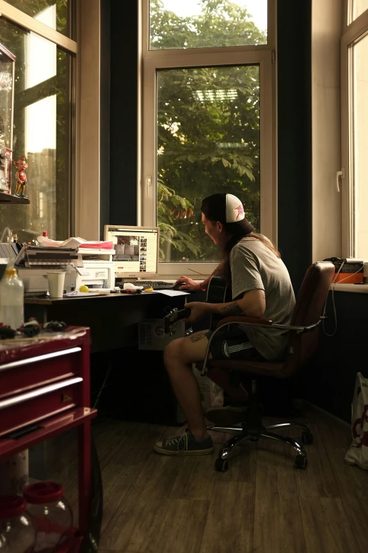 a man sitting at a desk working on his computer