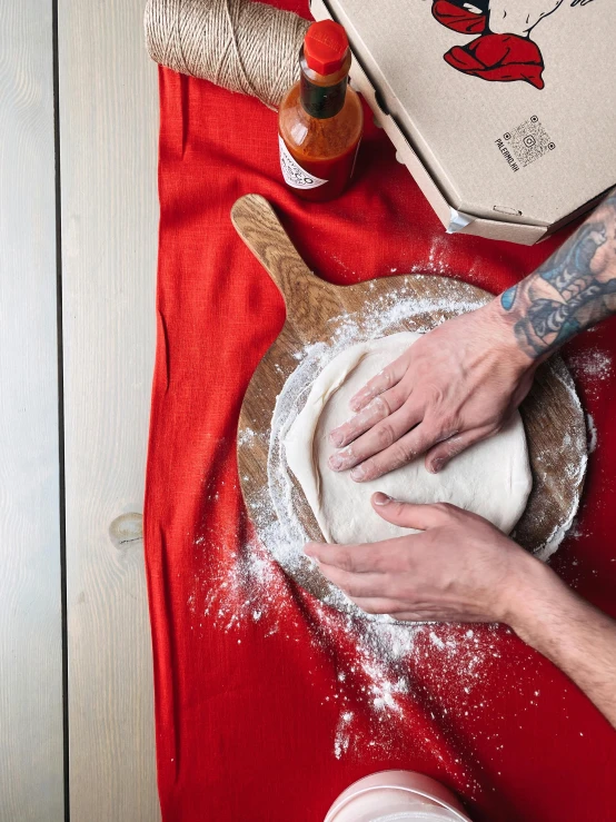 the person is rolling the dough in a bowl