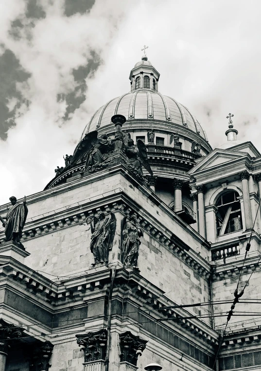 the top of a church with statues on the roof