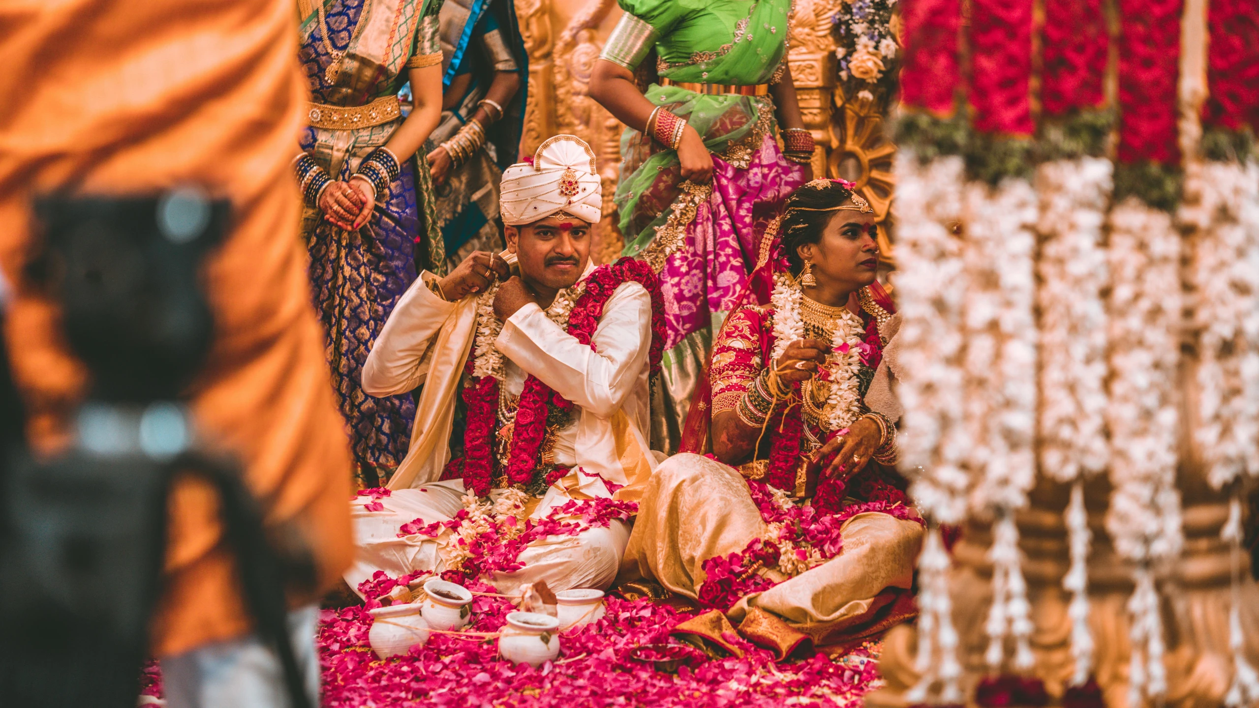 a bride is surrounded by her groom and their bridal party