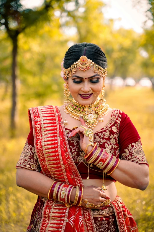 a woman in an indian dress, holding her hands together with a smile on her face