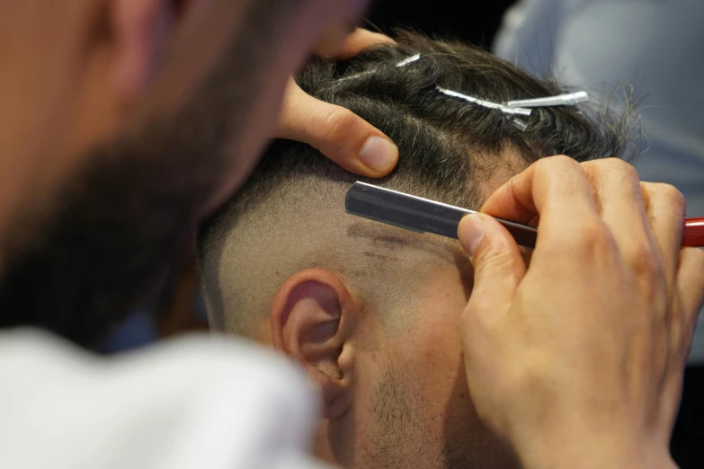 barber  male's hair with scissors and clippers