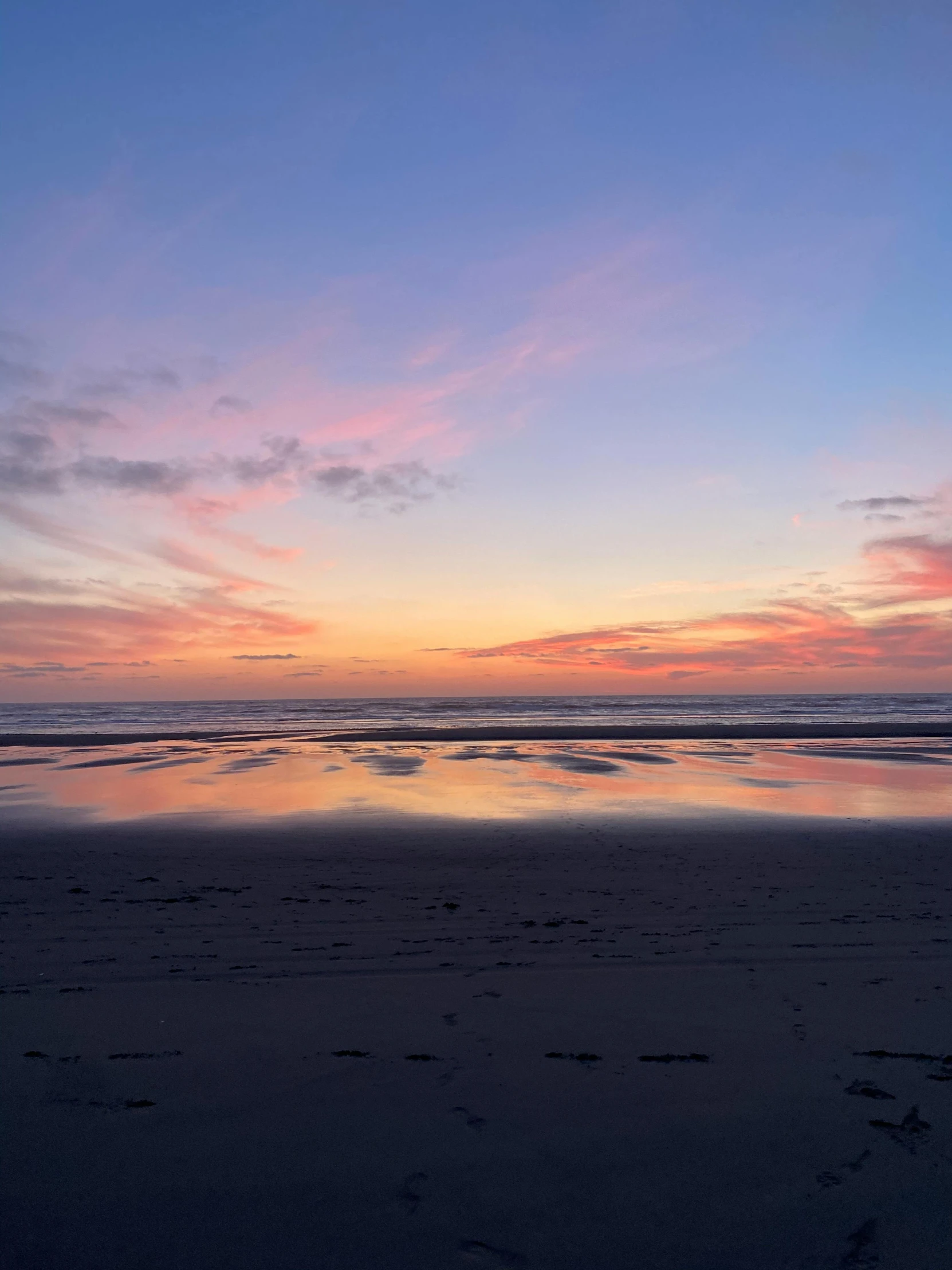 a bright sunset at the beach in silhouette