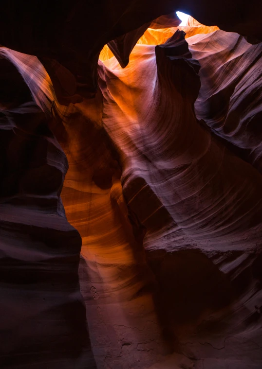 the light shining into a narrow open area of a canyon