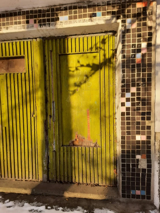 a building door with yellow and red tiles