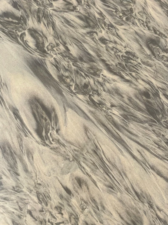 a picture with an ink filled texture of some water and sand
