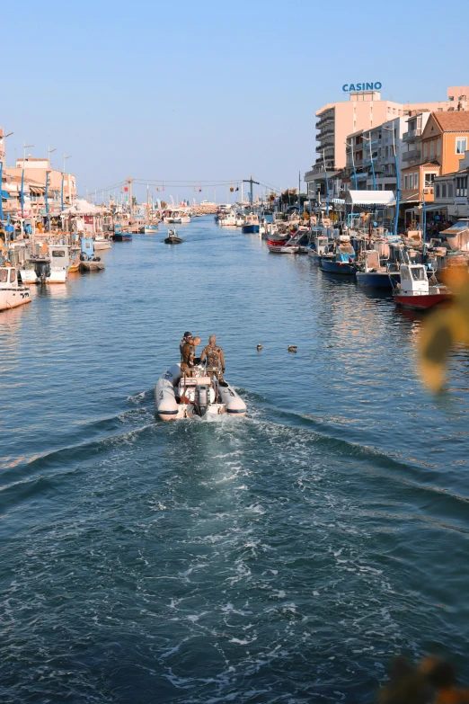 people are riding on a small boat in the middle of a body of water