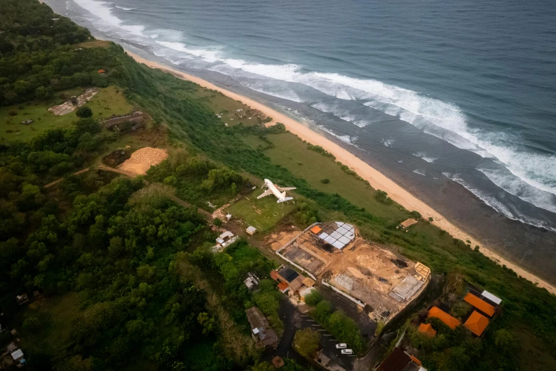 the plane is on the ground near the beach