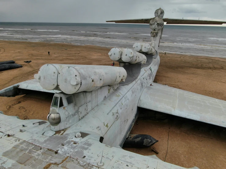 the large plane is old and abandoned on the beach