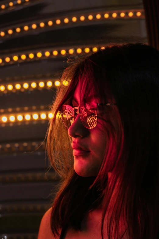 woman wearing goggles at night with large glowing balls