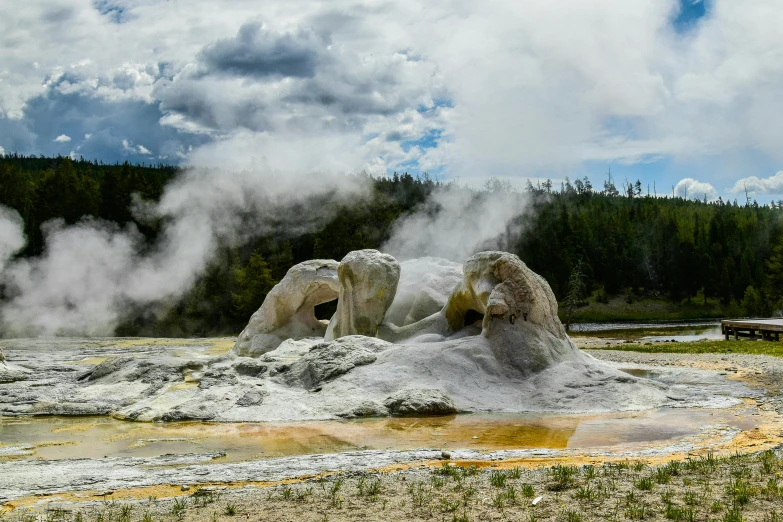 geysers blow up smoke in the distance as they travel by