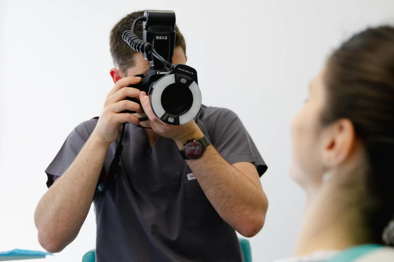 a man holding a camera up to his face