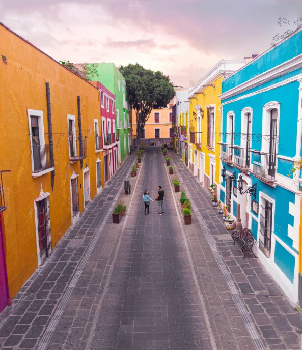 people are riding bicycles down an empty street in old town