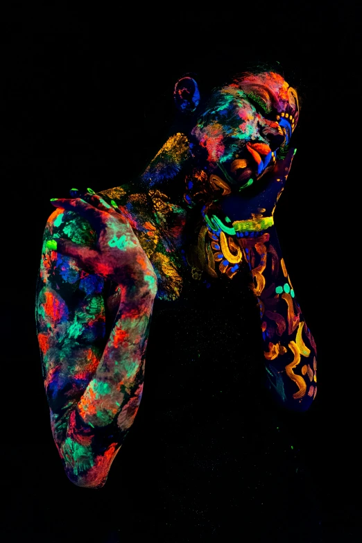 two colorful figures sitting side by side on a black background