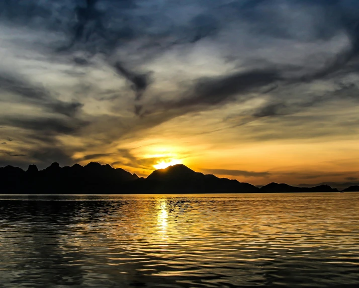 a boat on the water during a sunset