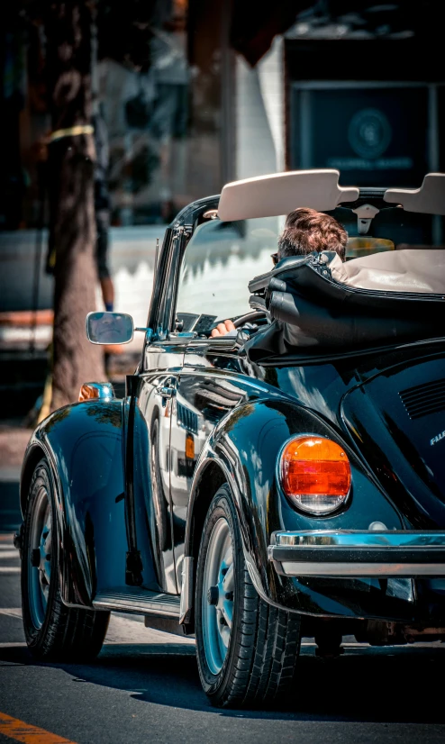 an old - fashioned convertible car with a top down