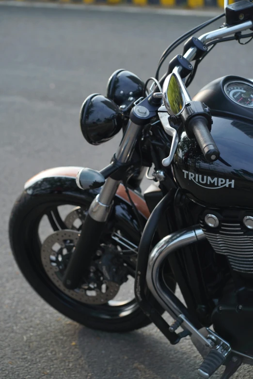 a close up of a parked motorcycle on the street