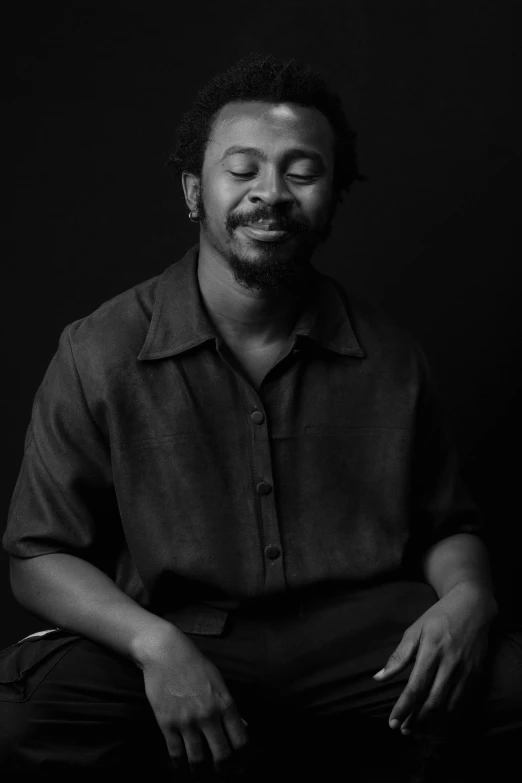 a black and white portrait of a person with his eyes closed