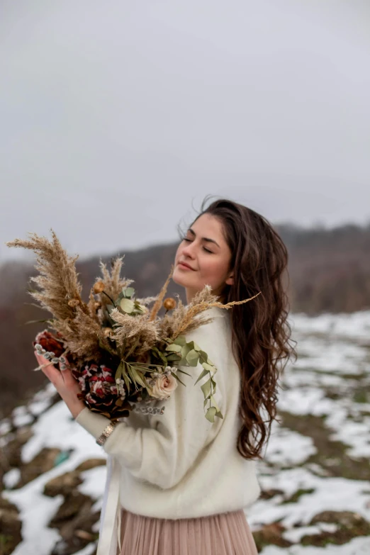 the woman is holding flowers in her hands